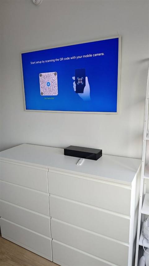 TV mounted above dresser